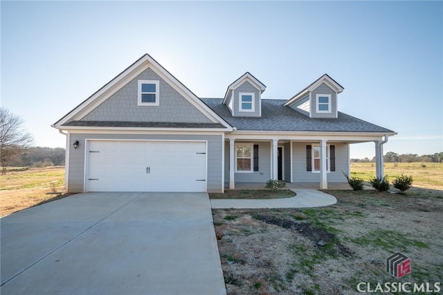 view of front of home featuring covered porch and a garage