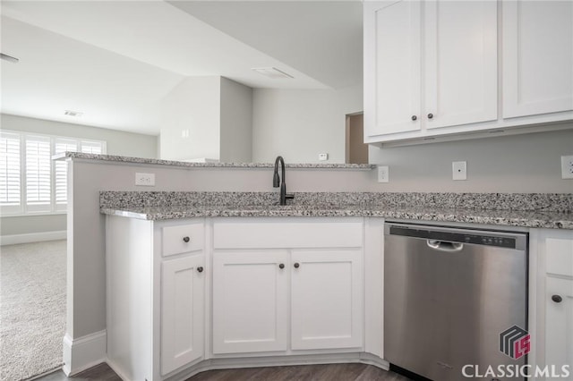 kitchen with white cabinetry, dishwasher, and sink