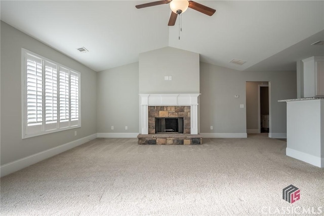 unfurnished living room with light colored carpet, a stone fireplace, ceiling fan, and lofted ceiling