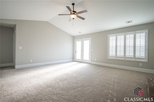 unfurnished room featuring carpet, ceiling fan, and vaulted ceiling