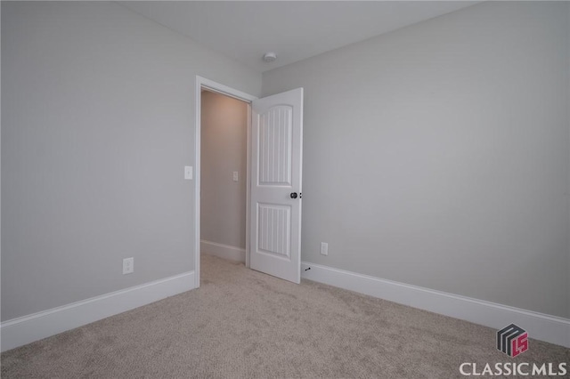 empty room featuring light carpet