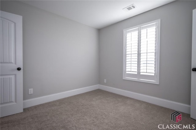 carpeted empty room featuring plenty of natural light