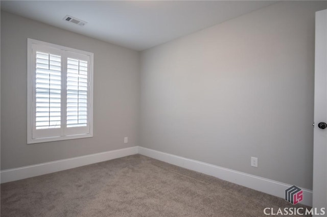 unfurnished room with light carpet