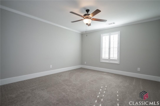 carpeted spare room with ceiling fan and ornamental molding