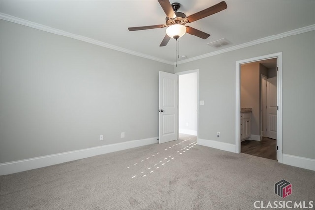 unfurnished bedroom with carpet flooring, ensuite bath, crown molding, and ceiling fan