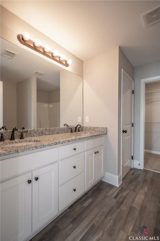 bathroom with vanity and wood-type flooring