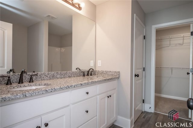 bathroom with hardwood / wood-style flooring and vanity