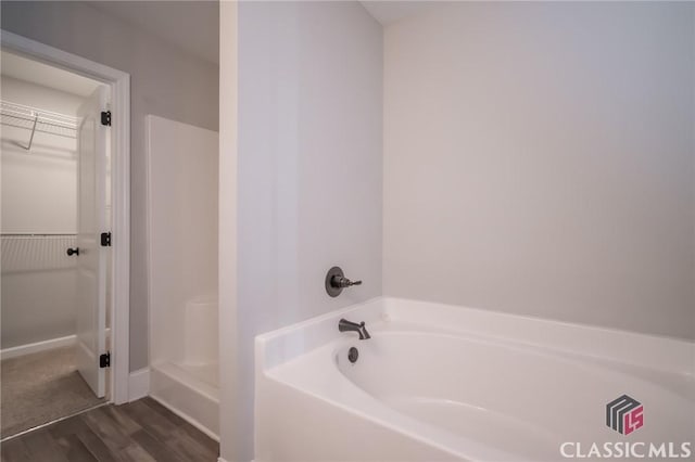 bathroom featuring hardwood / wood-style flooring and a bathtub