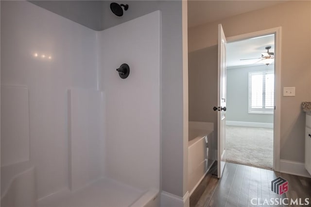 bathroom with ceiling fan, vanity, wood-type flooring, and walk in shower