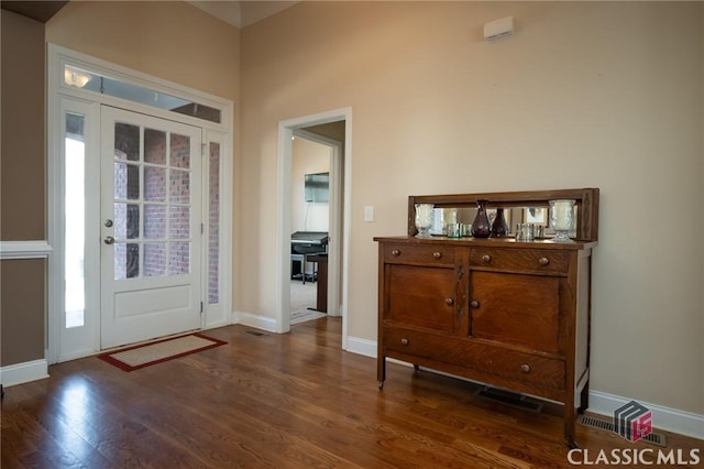 foyer entrance featuring dark hardwood / wood-style floors