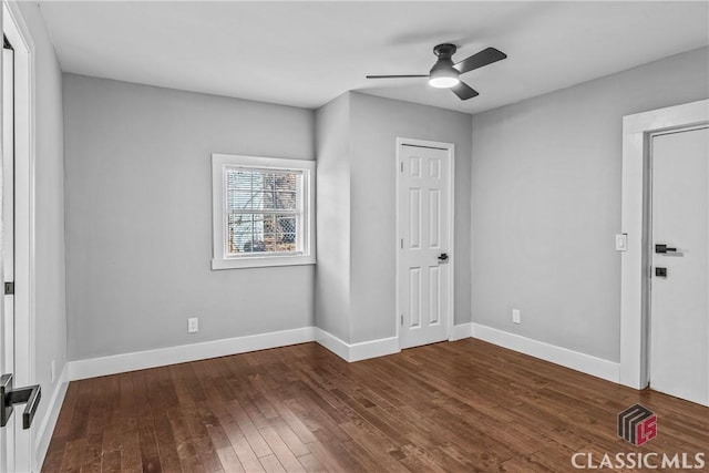 unfurnished bedroom featuring ceiling fan and dark wood-type flooring