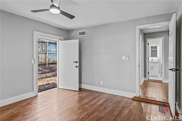 spare room featuring ceiling fan and hardwood / wood-style flooring