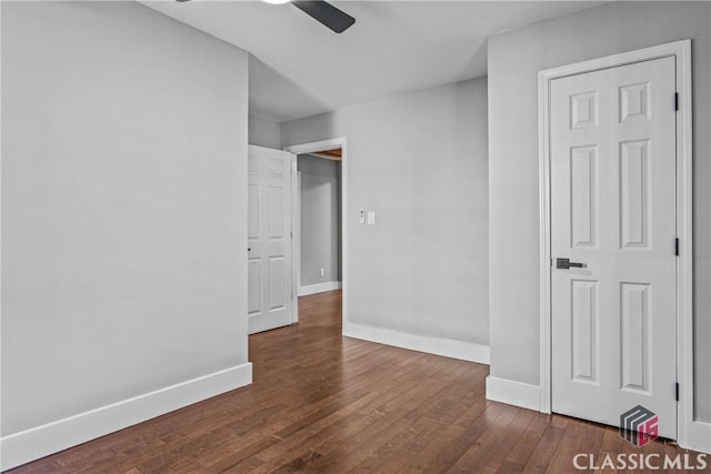 spare room featuring ceiling fan and dark wood-type flooring