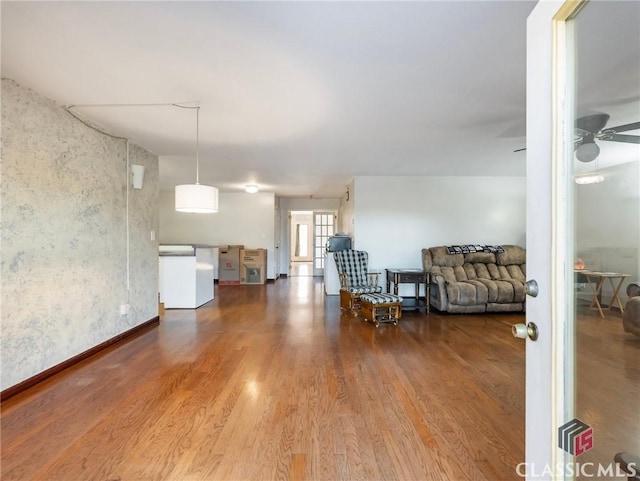 unfurnished room featuring ceiling fan and hardwood / wood-style flooring