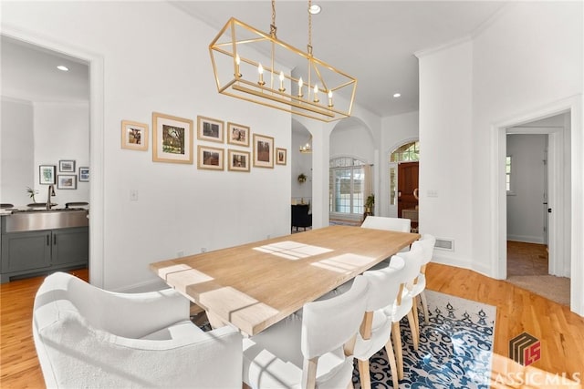 dining area featuring light wood-type flooring and sink