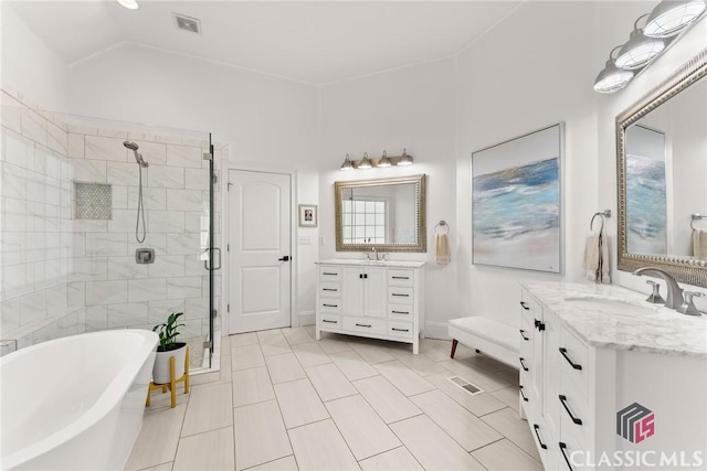 bathroom featuring tile patterned floors, vanity, and shower with separate bathtub