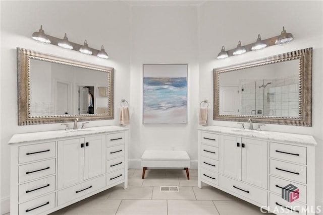 bathroom featuring a shower with door, vanity, and tile patterned flooring