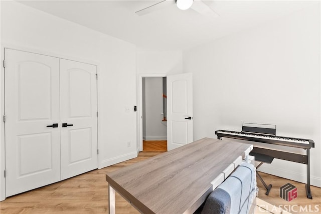 office with ceiling fan and light hardwood / wood-style flooring