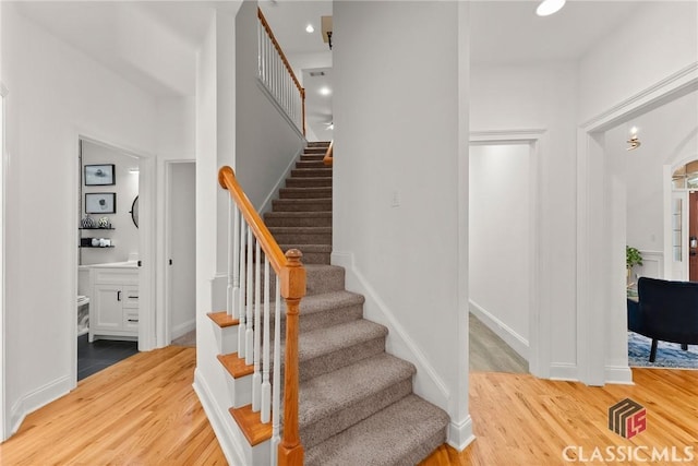 stairway with hardwood / wood-style floors