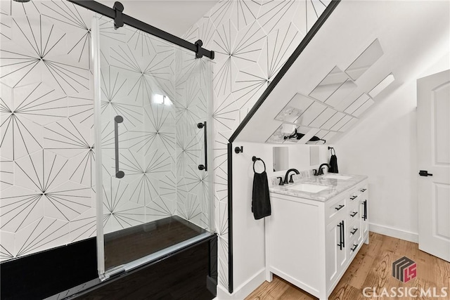 bathroom with vanity, hardwood / wood-style flooring, and walk in shower