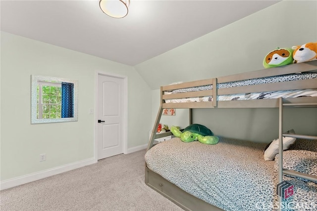 carpeted bedroom featuring vaulted ceiling