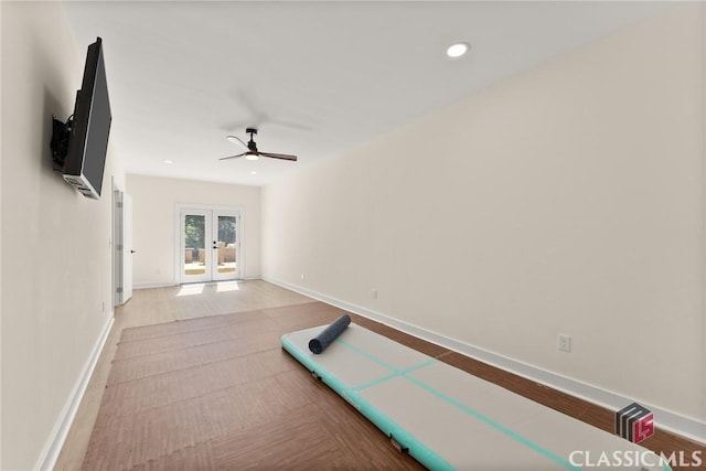 exercise room with ceiling fan, light hardwood / wood-style floors, and french doors