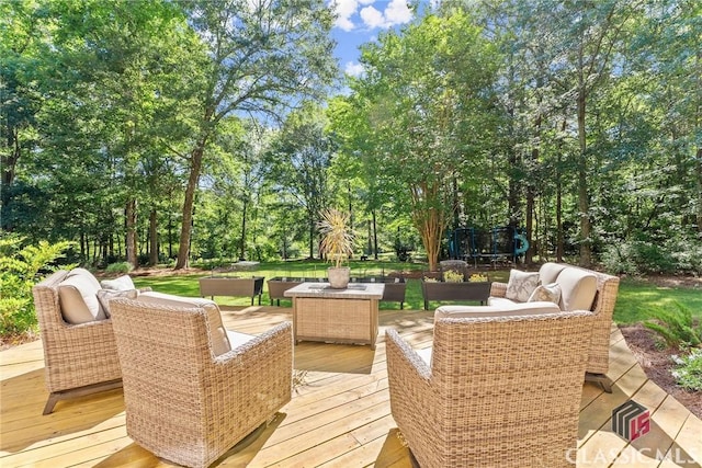 deck with an outdoor hangout area and a trampoline