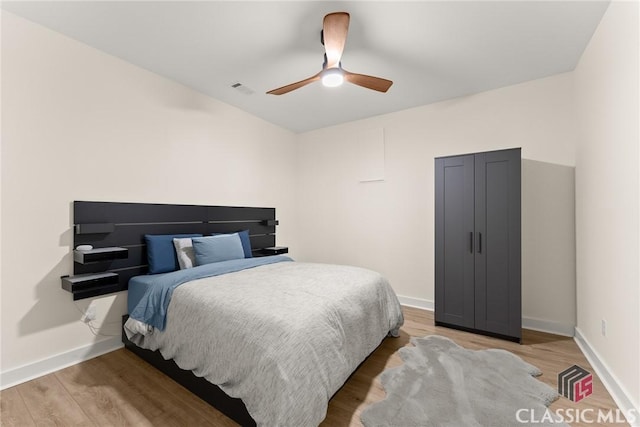 bedroom featuring ceiling fan and wood-type flooring