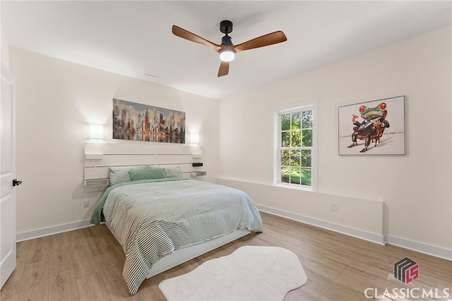 bedroom with hardwood / wood-style floors and ceiling fan