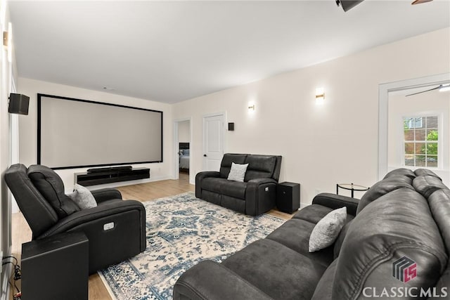 cinema room featuring ceiling fan and light hardwood / wood-style floors