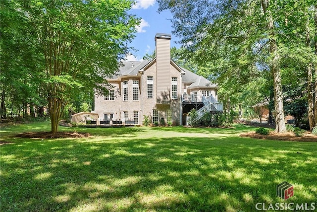 rear view of house with a lawn