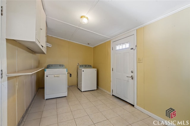 washroom with washer and dryer and cabinets