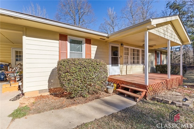 view of exterior entry featuring a deck