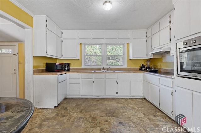 kitchen featuring white cabinets, a textured ceiling, sink, and black appliances