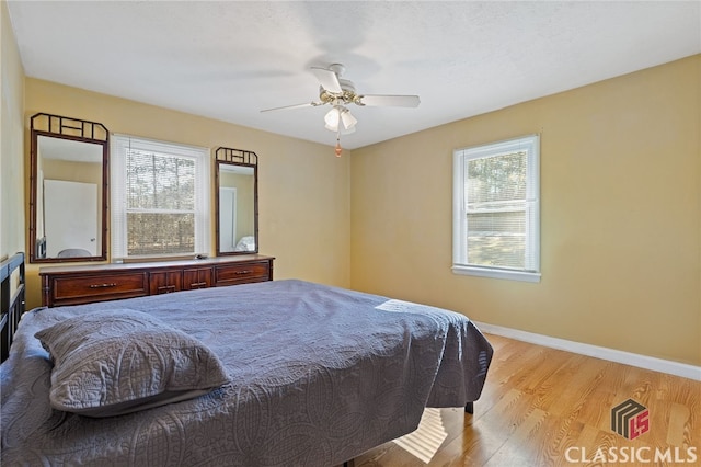 bedroom with light hardwood / wood-style floors and ceiling fan