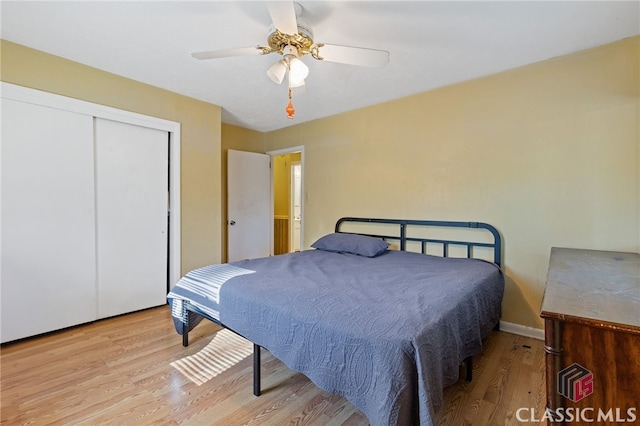 bedroom with a closet, ceiling fan, and light hardwood / wood-style floors