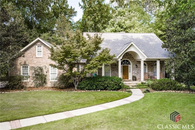 view of front of property featuring a porch and a front lawn