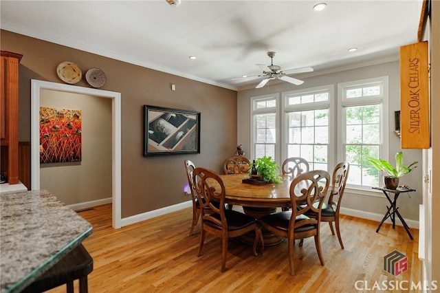 dining room featuring ceiling fan, light wood-type flooring, and ornamental molding