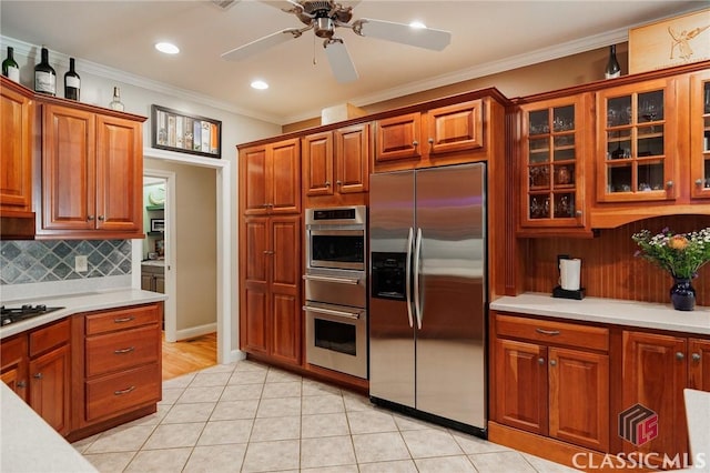 kitchen with ceiling fan, stainless steel built in refrigerator, ornamental molding, and light tile patterned floors