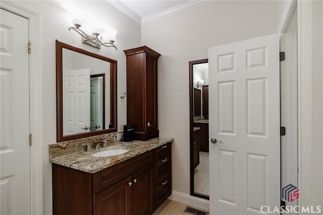 bathroom with vanity and crown molding