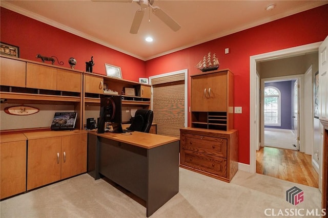 carpeted home office with ceiling fan and ornamental molding