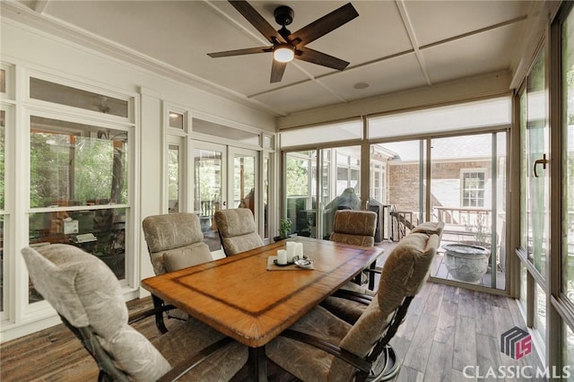 sunroom / solarium featuring ceiling fan and french doors