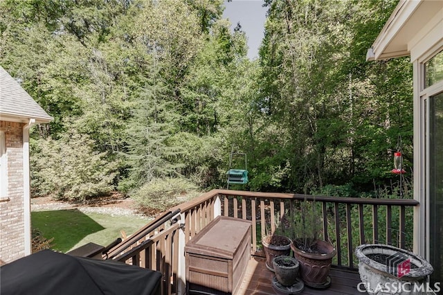 wooden terrace with a grill