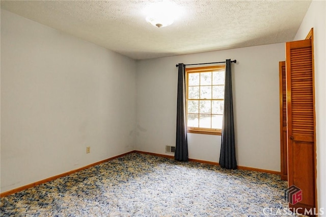 empty room featuring a textured ceiling