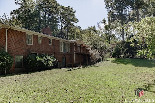 view of yard with central AC and a wooden deck