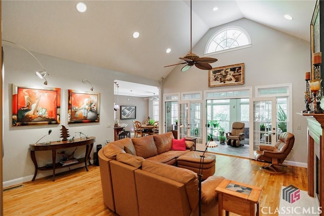 living room with french doors, light wood-type flooring, high vaulted ceiling, and ceiling fan