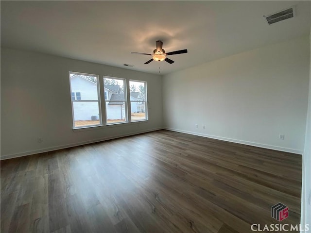 empty room featuring ceiling fan and dark hardwood / wood-style flooring