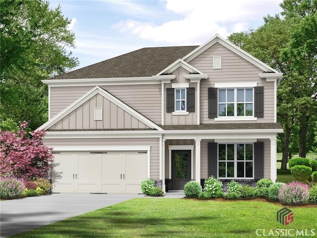 craftsman house with a front yard and a garage