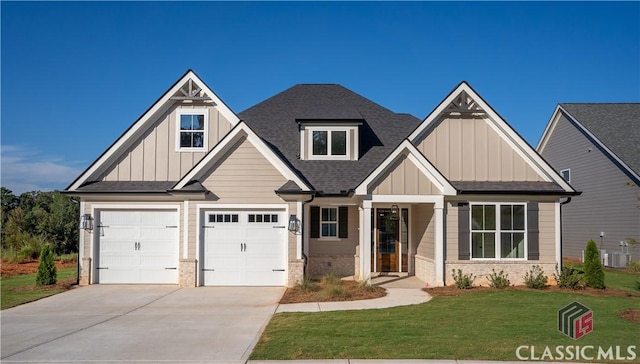 craftsman-style house featuring a front yard and central AC unit