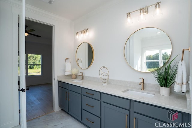 bathroom with crown molding, plenty of natural light, vanity, and ceiling fan